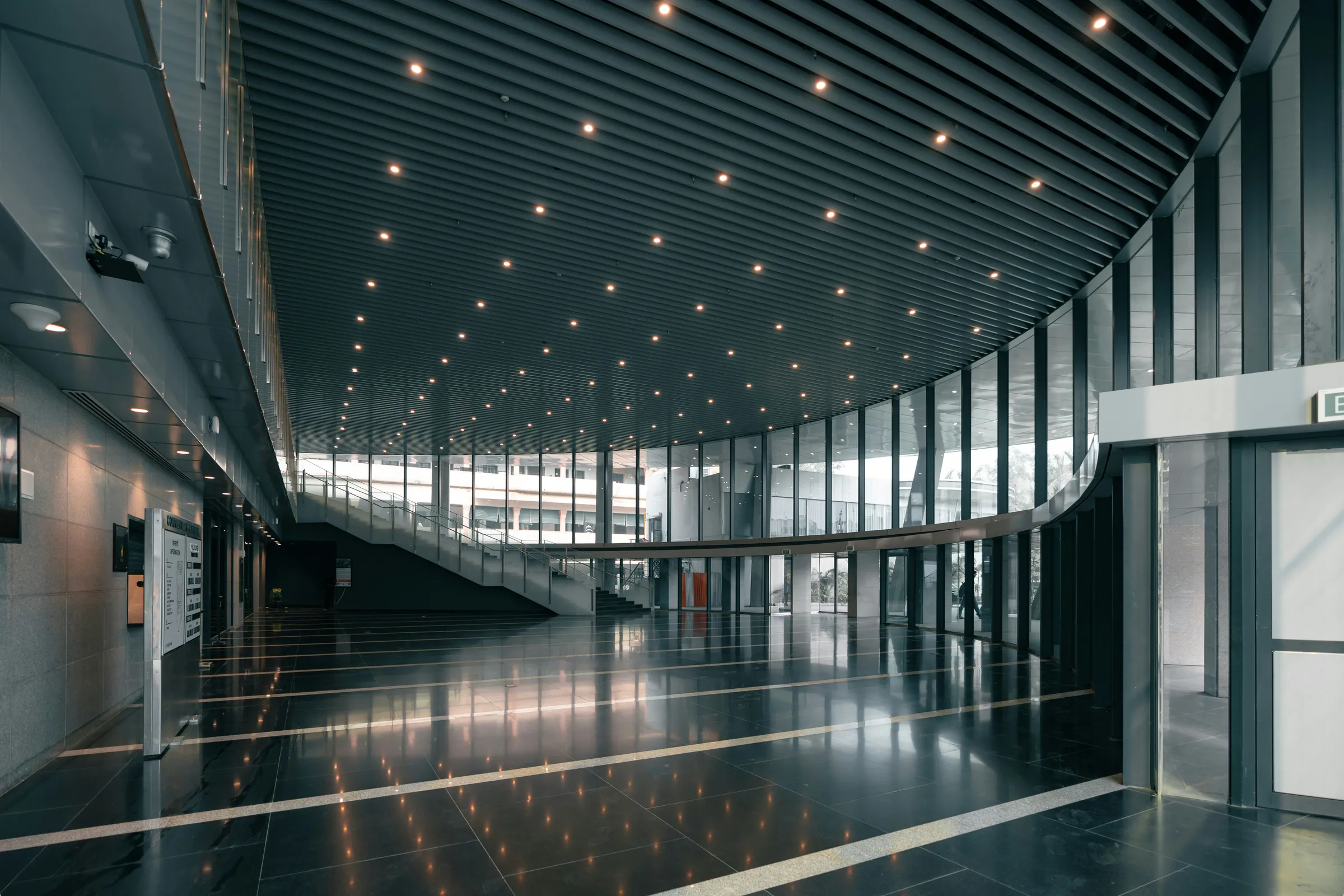 A premium convention centre lobby at dusk, ready for an event